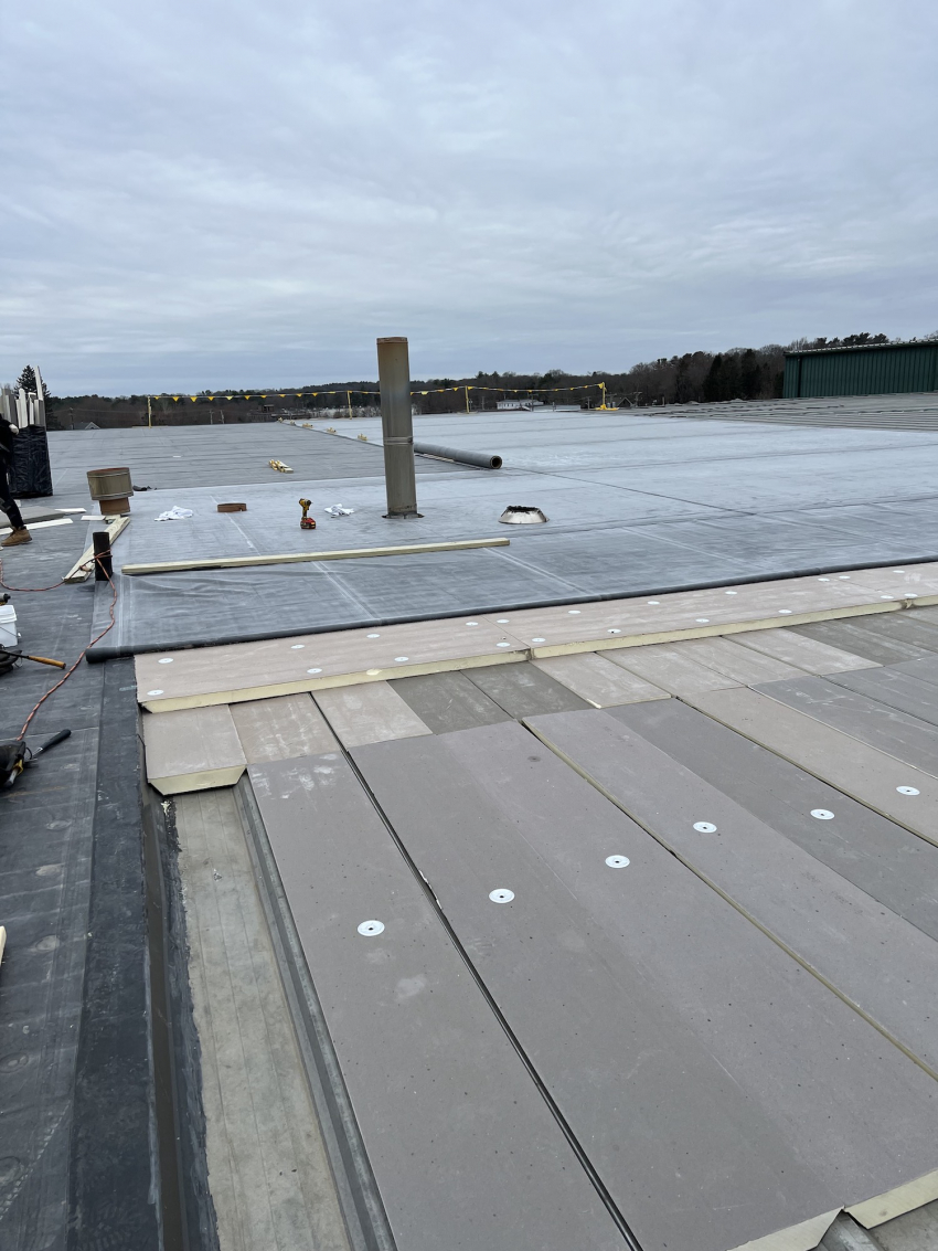 Rubber roof diagram photo showing old metal roof underneath as well as custom-cut insulation panels with rubber roof over it