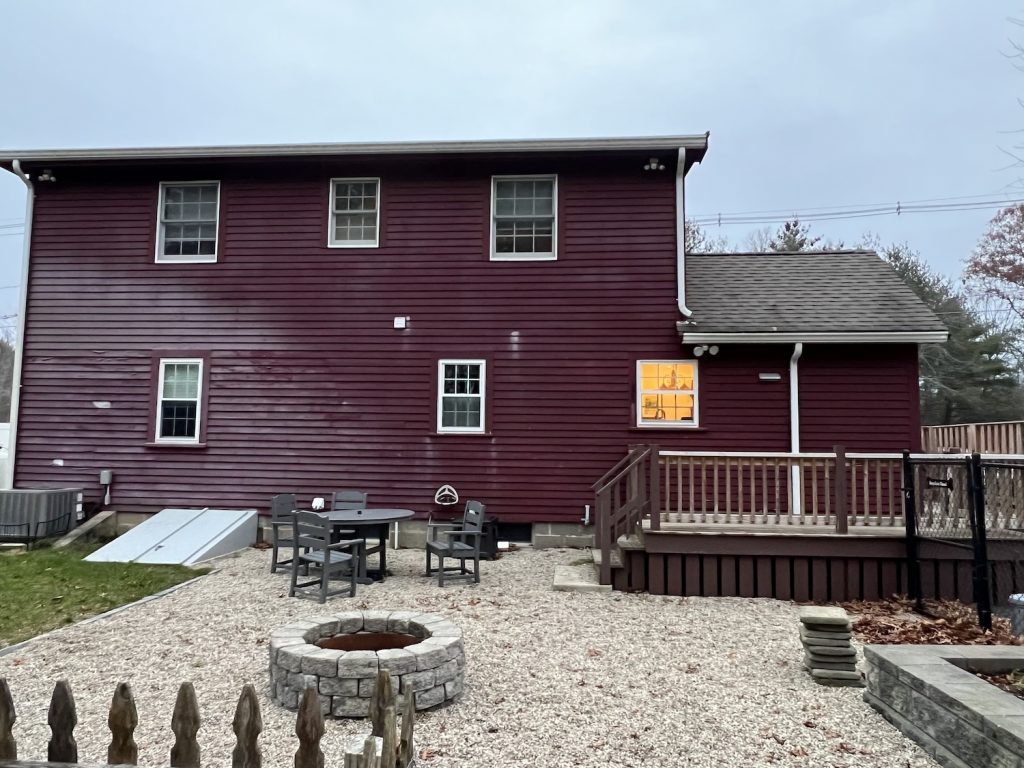 Rear of home with red siding